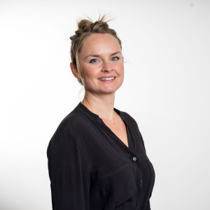 Image of a woman in a black shirt looking at the camera.