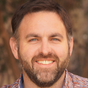 Close up image of a man with dark hair and beard.