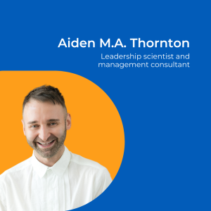 Image of a man with short dark hair, wearing a white shirt against an orange background.