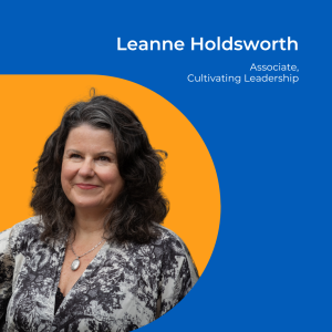 Image of a woman with mid length dark wavy hair and a black and white top on an orange background.