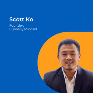 Image of a man with short dark hair and suit jacket against an orange background.