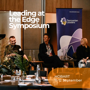 Image of three people seated, smiling in conversation