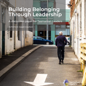 photo of a man walking up a laneway with his back towards the viewer