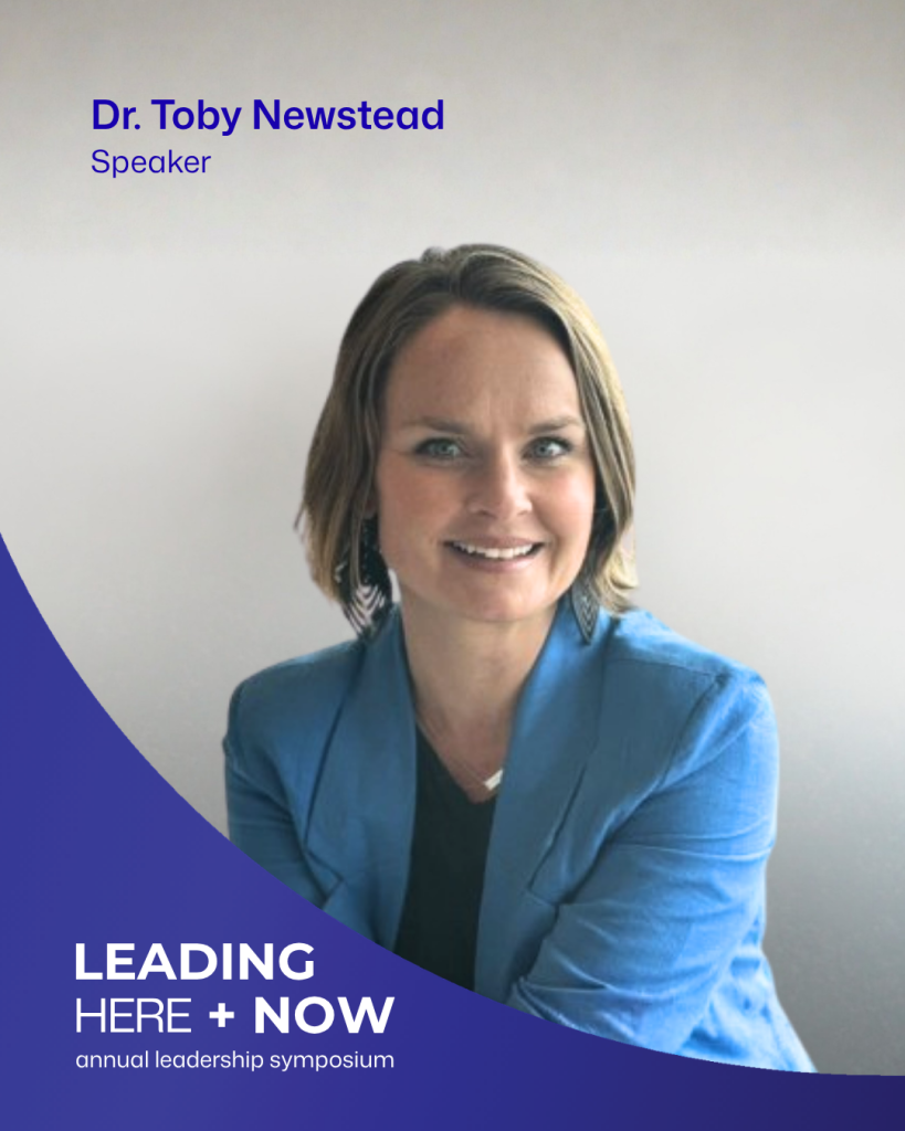 Dr Toby Newstead smiling at the camera, wearing a bright blue jacket over a black top. The graphic identifies her as a speaker at Leading Here + Now.